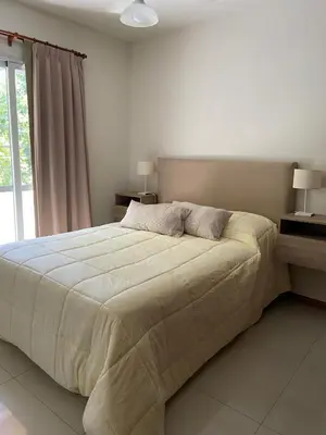 a bedroom with a large bed and a window at Apartment Carlos Paz in Villa Carlos Paz