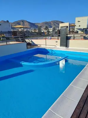 a swimming pool with blue water on top of a building at Apartment Carlos Paz in Villa Carlos Paz
