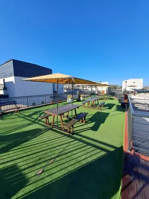 a group of picnic tables on the roof of a building at Apartment Carlos Paz in Villa Carlos Paz