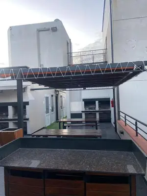 a balcony with a picnic table in a building at Apartment Carlos Paz in Villa Carlos Paz