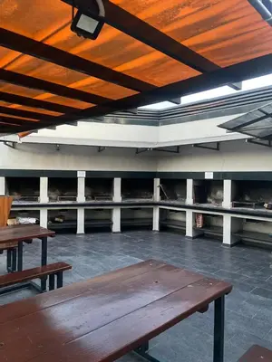 a room with two wooden tables in a building at Apartment Carlos Paz in Villa Carlos Paz