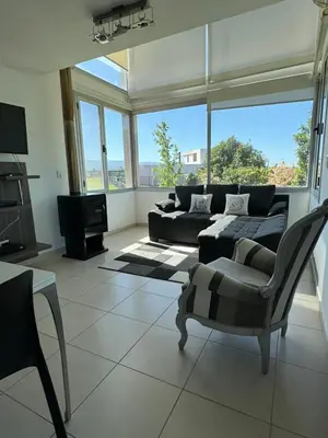 a living room with a couch and a chair at Casa Paris Puerto del Aguila in Potrero de Garay