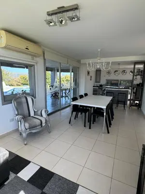 a kitchen and dining room with a table and chairs at Casa Paris Puerto del Aguila in Potrero de Garay