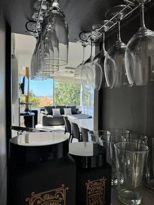 a restaurant with wine glasses and tables and chairs at Casa Paris Puerto del Aguila in Potrero de Garay
