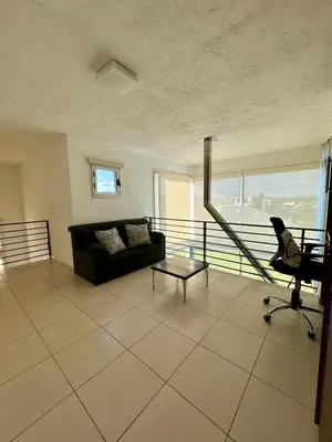 a living room with a couch and a chair at Casa Paris Puerto del Aguila in Potrero de Garay