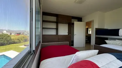 a bedroom with two beds and a large window at Casa Paris Puerto del Aguila in Potrero de Garay