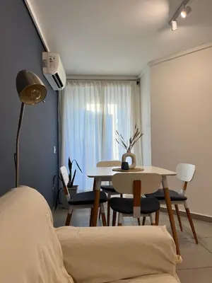 a living room with a table and a dining room at Departamento cómodo y confortable en Córdoba Capital in Cordoba