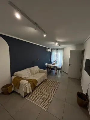 a bedroom with a bed and a table in it at Departamento cómodo y confortable en Córdoba Capital in Cordoba