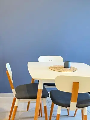 a white table with two chairs and a cup on it at Departamento cómodo y confortable en Córdoba Capital in Cordoba