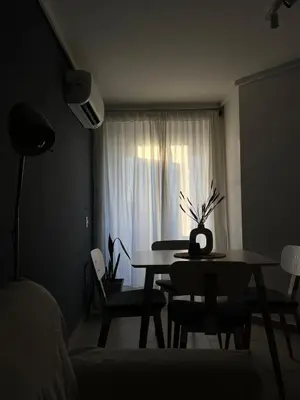 a dining room with a table and a window at Departamento cómodo y confortable en Córdoba Capital in Cordoba