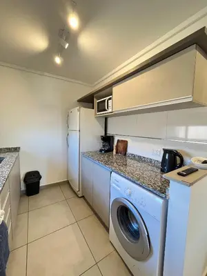 a kitchen with a washer and dryer in it at Departamento cómodo y confortable en Córdoba Capital in Cordoba