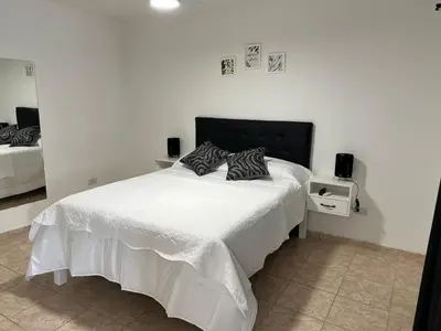 a bedroom with a white bed with two pillows on it at Bella Luna apart in Mina Clavero