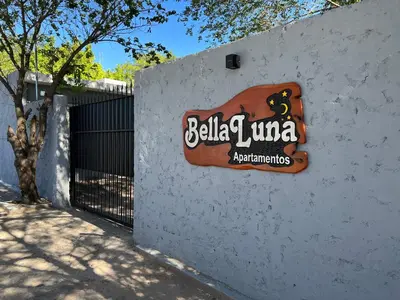 a sign on the side of a wall at Bella Luna apart in Mina Clavero