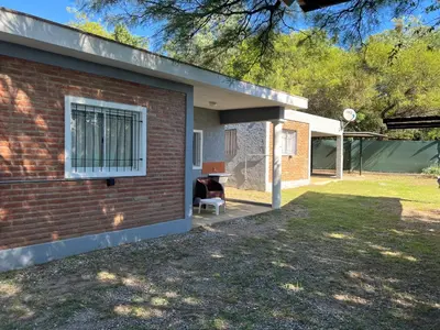 a brick house with a window and a chair at Bella Luna apart in Mina Clavero