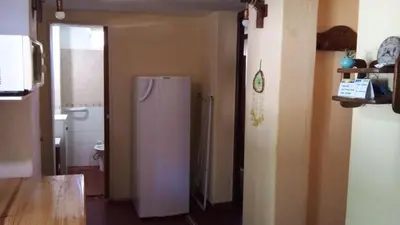 a kitchen with a refrigerator in a room at Alojamiento frente al Arroyo Cristal in Tanti