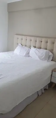 a large white bed with white pillows on it at CR Apartment in Cordoba