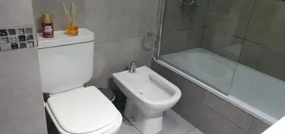 a bathroom with a toilet and a shower and a sink at CR Apartment in Cordoba