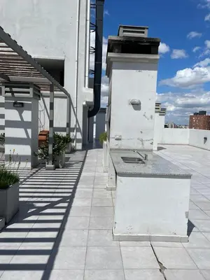a building with a counter on top of a patio at CR Apartment in Cordoba