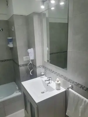 a bathroom with a sink and a mirror at CR Apartment in Cordoba