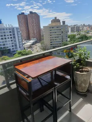 a table on a balcony with a view of a city at CR Apartment in Cordoba