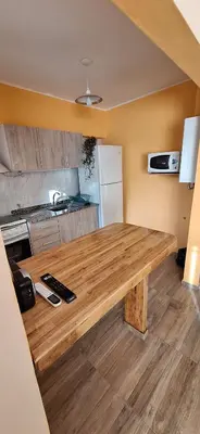 a kitchen with a wooden table in a room at Patuli House - Casa alquiler temporario Córdoba in Cordoba