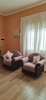 a living room with two couches and a window at Patuli House - Casa alquiler temporario Córdoba in Cordoba