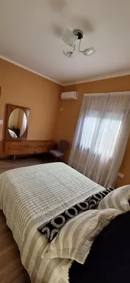 a bedroom with a large bed and a mirror at Patuli House - Casa alquiler temporario Córdoba in Cordoba