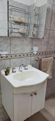 a bathroom with a white sink and a mirror at Patuli House - Casa alquiler temporario Córdoba in Cordoba