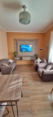 a living room with couches and a flat screen tv at Patuli House - Casa alquiler temporario Córdoba in Cordoba