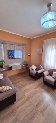 a living room with two couches and a flat screen tv at Patuli House - Casa alquiler temporario Córdoba in Cordoba