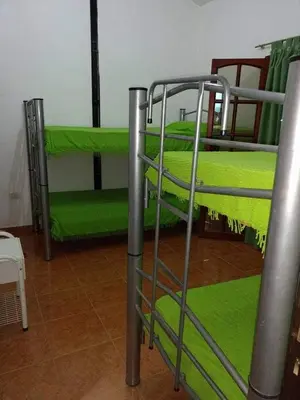 two bunk beds in a room with green at Tu lugar en Tierra Santa in Villa Cura Brochero