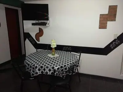 a dining room table with a black and white table cloth at Tu lugar en Tierra Santa in Villa Cura Brochero
