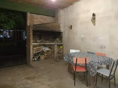 a dining room with a table and chairs in a room at Tu lugar en Tierra Santa in Villa Cura Brochero
