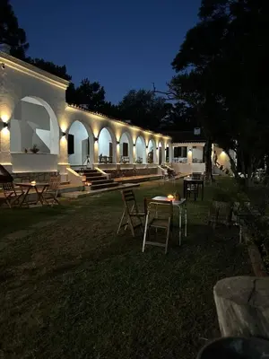 a building with a table and chairs at night at La Posta del Jesuita in Villa Los Aromos