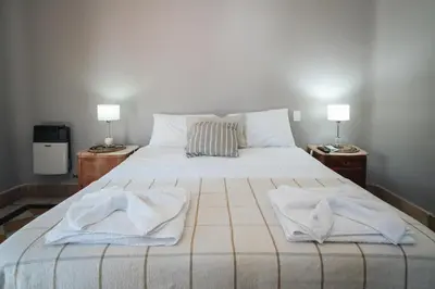 a bedroom with a bed with towels on it at La Posta del Jesuita in Villa Los Aromos