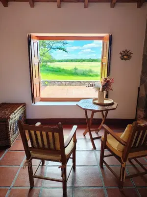 a room with a table and chairs and a window at Posta Calma inmerso en la naturaleza in San Agustín