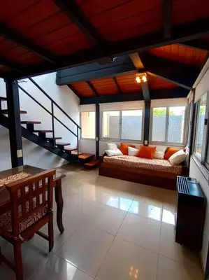 a living room with a couch and a staircase at Cómodo Depto en B Villa Belgrano in Cordoba