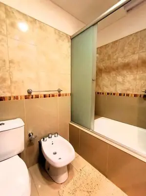 a bathroom with a toilet and a sink and a tub at Cómodo Depto en B Villa Belgrano in Cordoba