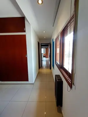 a hallway of a building with a door and a window at Cómodo Depto en B Villa Belgrano in Cordoba