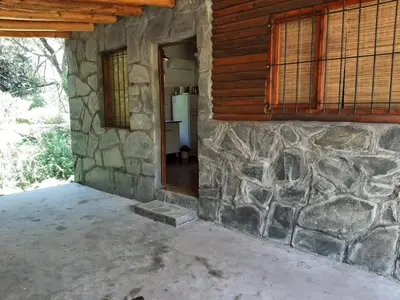 an entrance to a stone building with a stone wall at La vertiente in Villa Yacanto