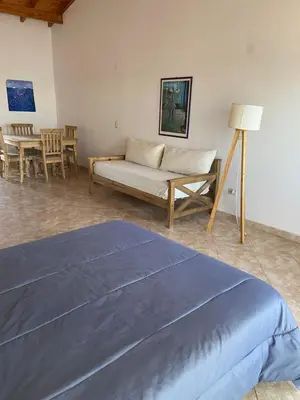 a living room with a bed and a couch at La Casita Yogui - MONOAMBIENTE 1 in Santa Rosa de Calamuchita