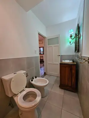 a bathroom with a toilet and a sink at Martinolli5130 in Cordoba