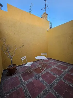a patio with a table and chairs next to a wall at Martinolli5130 in Cordoba