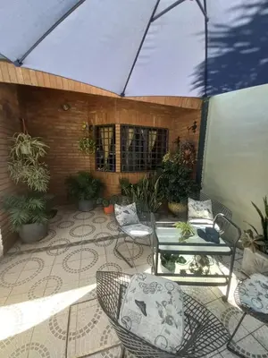 a patio with a table and chairs and plants at Departamento interno con dos camas individuales in Cordoba
