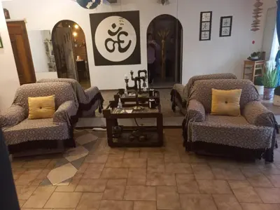 a living room with two chairs and a table at Departamento interno con dos camas individuales in Cordoba
