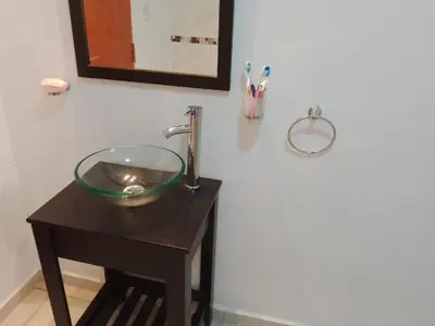 a bathroom sink with a glass bowl on a table at Casa Villa Amancay in Villa Amancay