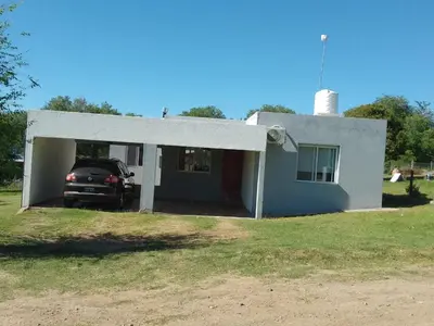 a house with a car in the garage at Casa Villa Amancay in Villa Amancay