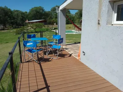 a deck with blue chairs and a table on it at Casa Villa Amancay in Villa Amancay