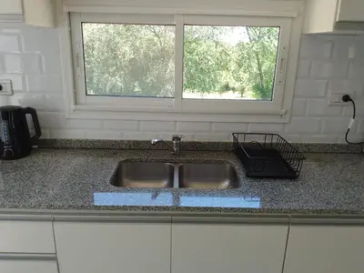 a kitchen counter with a sink and a window at Casa Villa Amancay in Villa Amancay