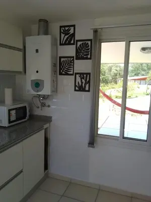 a kitchen with a microwave and a window in it at Casa Villa Amancay in Villa Amancay